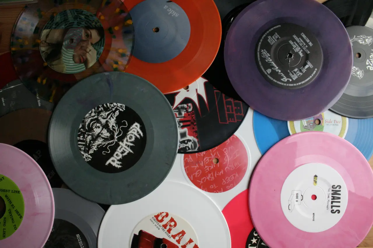 7 inch vinyl records scattered on a table